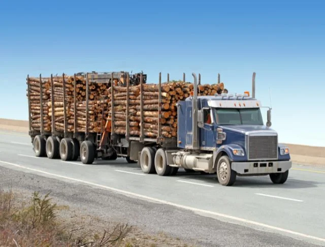a fully loaded flatbed with woods